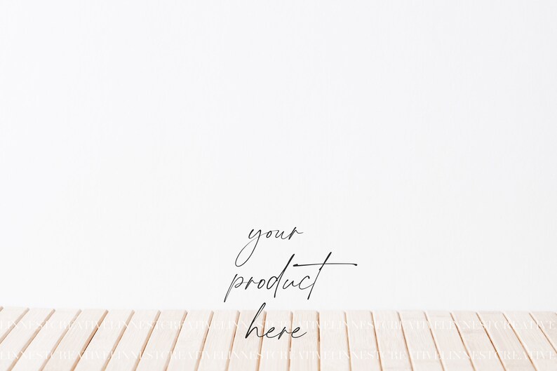 May include: A white wall with a wooden floor. The text "your product here" is written in black cursive on the wall.