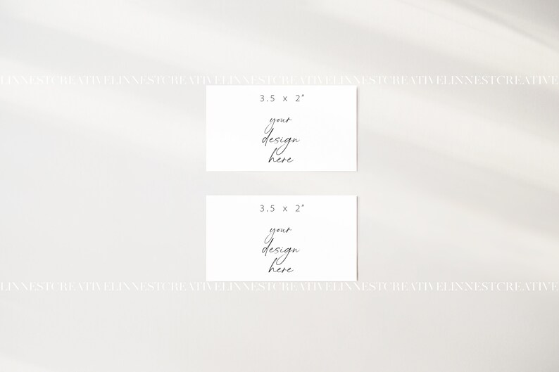 May include: Two blank white cards, each measuring 3.5 inches by 2 inches, with the text "your design here" written in black cursive on each card.