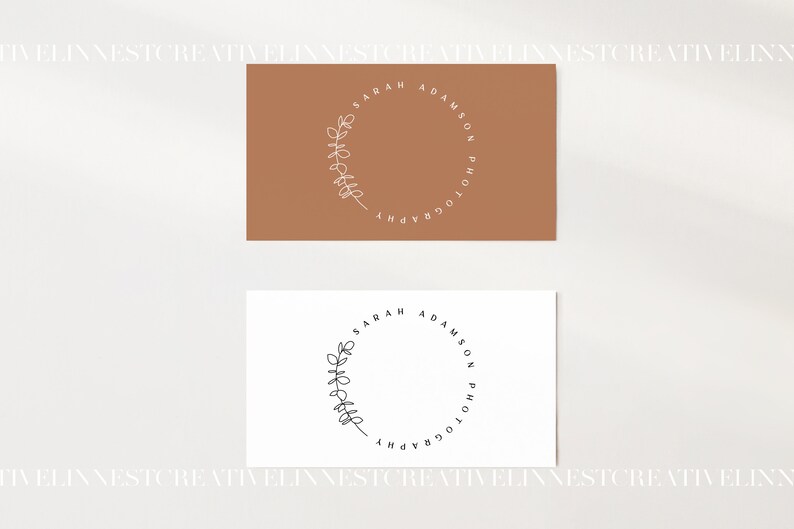 May include: Two business cards with a brown and white background. The text on the cards reads "Sarah Adamson Photography" in a circle with a branch design.