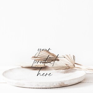 May include: A white ceramic plate with a natural palm leaf arrangement on top. The text "your product here" is written in black cursive on the plate.