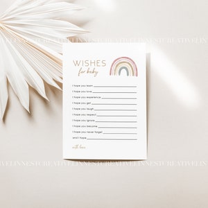 Pu&ograve; includere: Un biglietto stampabile con un design arcobaleno e il testo "WISHES for baby". Il biglietto ha righe per scrivere gli auguri per un neonato.