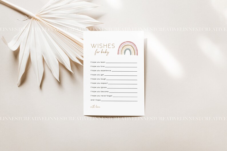 Pu&ograve; includere: Un biglietto stampabile con un design arcobaleno e il testo "WISHES for baby". Il biglietto ha righe per scrivere gli auguri per un neonato.