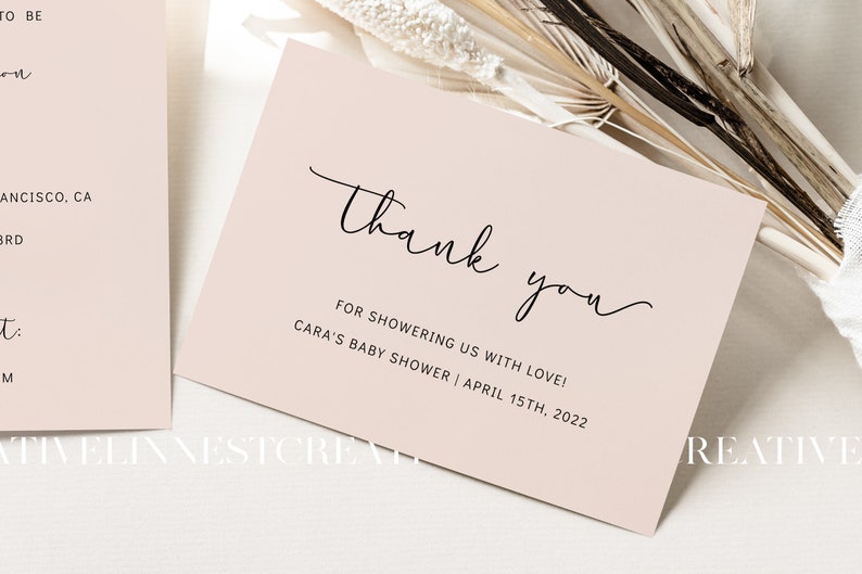 May include: A thank you card with a simple script font that says "Thank you" and the text "For showering us with love! Cara's Baby Shower | April 15th, 2022". The card is a light pink color.