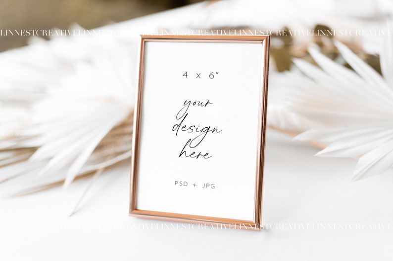 May include: A rose gold picture frame with a white mat and a white background. The frame is 4 inches by 6 inches and has the text "your design here" and "PSD + JPG" printed on it.