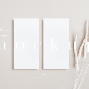 May include: Two blank white cards with the text "Wedding Program" and "MOCKUP" on a beige background with dried white pampas grass.