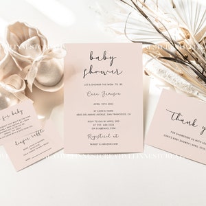 May include: A pink baby shower invitation with the text "baby shower" and "Let's shower the mom to be Cara Jameson" in black script font. The invitation includes the date, location, RSVP information, and registry details. A thank you card with the text "Thank you for showering us with love! Cara's baby shower April 15th, 2022" is also included.
