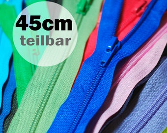 May include: A collection of multi-colored zippers in shades of blue, green, red, and pink, each measuring 45cm in length. The zippers feature matching plastic sliders and teeth, with a circular overlay displaying the text 45cm teilbar.