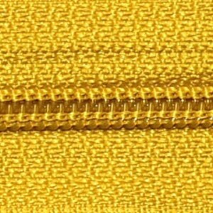May include: Close-up of a gold zipper with a yellow fabric tape.
