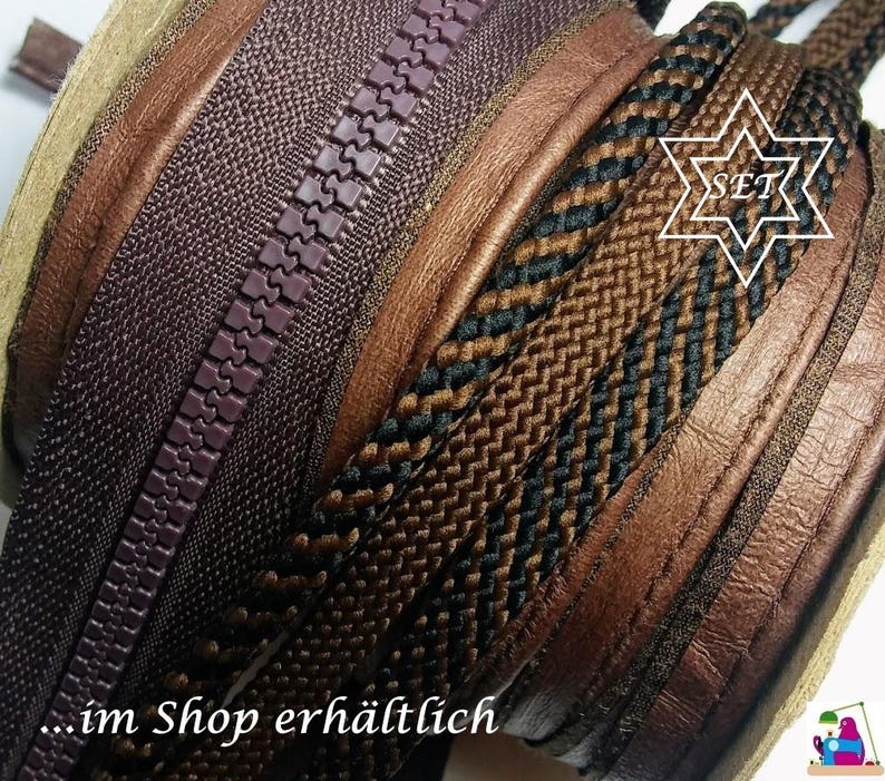 May include: A coiled set of sewing supplies featuring a dark brown plastic zipper, a smooth tan leather strip, and two braided cords in black and brown. The image includes a white star-shaped graphic with the text SET and the text im Shop erh&auml;ltlich.
