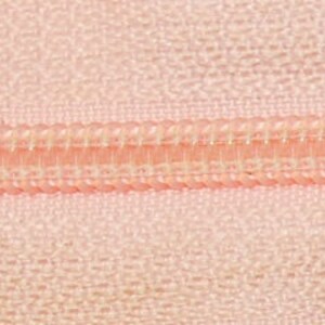 May include: Close-up of a pink zipper with a white zipper tape.