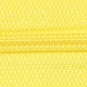 May include: Close-up of a yellow zipper with a smooth, textured surface.