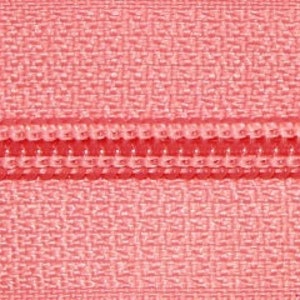 May include: Close-up of a pink zipper with a red zipper pull.