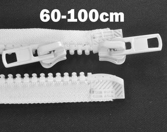 May include: Close-up of white zippers with sliders. The text "60-100cm" is displayed at the top. The zippers are made of plastic and are designed for various sewing projects. The image shows the zipper teeth and the slider mechanism.