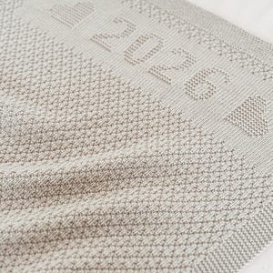 Patrón de punto para la manta del primer año del bebé 2026 – Diseño personalizado – Instrucciones en inglés, alemán y francés.