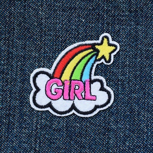 May include: A rainbow with a yellow star on top, in a white cloud with the word "GIRL" in pink letters.