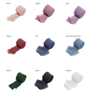 May include: Nine spools of decorative ribbon in various colors, including pink, purple, red, blue, green, black, and white. Each spool is unrolled slightly, showing the texture and color variations. The names of the colors are written above each spool.