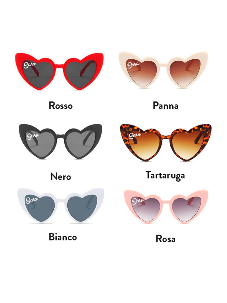 May include: Heart-shaped sunglasses in six colors: red, cream, black, tortoise shell, white, and pink. Each pair has the name "Sara" printed on the upper left lens. The sunglasses have dark lenses and a retro style.
