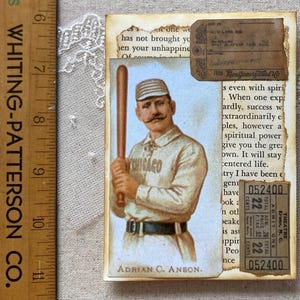 May include: A vintage baseball card featuring Adrian C. Anson, a player for the Chicago White Stockings. The card is in a cream color with a blue background and features a photo of Anson holding a baseball bat. The card also includes the text "Adrian C. Anson" and "Chicago".