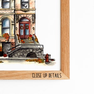May include: Watercolor illustration of a brownstone building with a red door and a stone stoop. The building is decorated with fall foliage and pumpkins. The illustration is framed in a wooden frame with the text "CLOSE UP DETAILS" at the bottom.