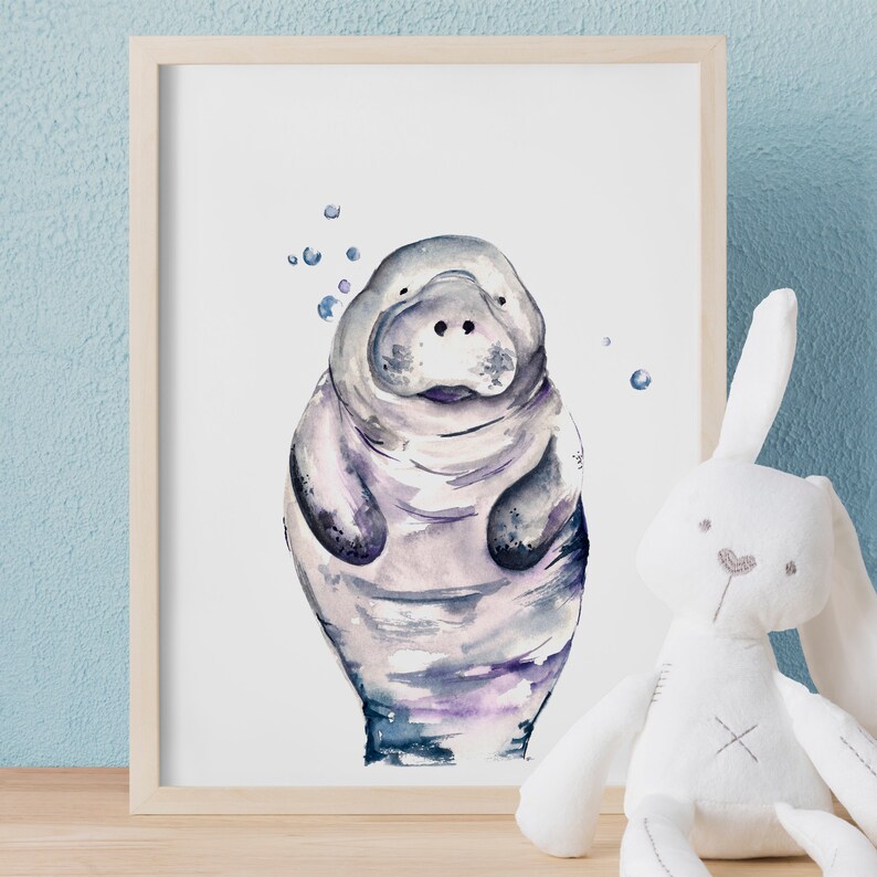 May include: A watercolor painting of a manatee with a light purple and blue color scheme. The manatee is surrounded by small blue circles, resembling bubbles.