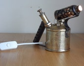 Vintage brass blow torch converted to stylish table lamp with internal illumination small globe bulb.