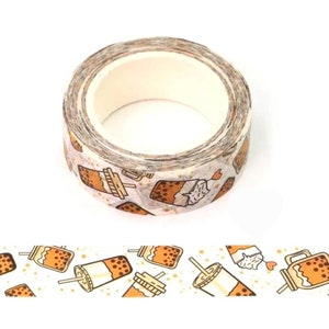 May include: A roll of washi tape with a white background and a repeating pattern of brown bubble tea cups with straws and gold glitter.