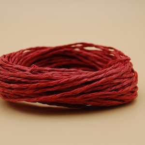 May include: A roll of red paper twine, ideal for wrapping gifts or adding a rustic touch to crafts.