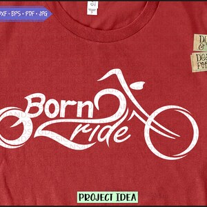 May include: White graphic design on a red t-shirt featuring a motorcycle with the text "Born to Ride".