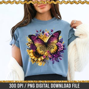 May include: A light blue t-shirt with a colourful butterfly design, featuring purple and yellow wings, and floral elements. The shirt has the text "300 DPI / PNG DIGITAL DOWNLOAD FILE".