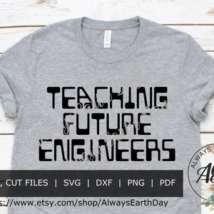 May include: A grey t-shirt with black text that reads "TEACHING FUTURE ENGINEERS". The text is surrounded by a floral pattern. The bottom of the shirt has the text "PRINT, CUT FILES | SVG | DXF | PNG | PDF" and a website address. The bottom right corner of the shirt has a logo with the text "ALWAYS EARTH DAY" and the letters "AED" in a circle.
