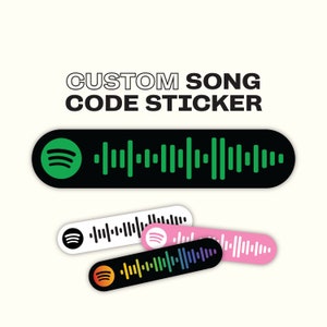 May include: Three different versions of a custom song code sticker. The top sticker is black with a green Spotify logo and a barcode. The middle sticker is white with a black Spotify logo and a barcode. The bottom sticker is black with a rainbow Spotify logo and a barcode.