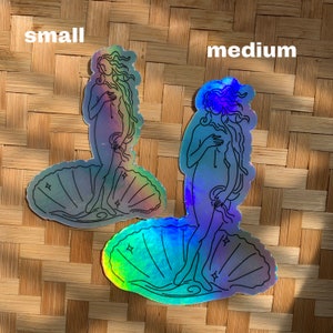 May include: Two iridescent holographic stickers of the Birth of Venus, a famous Renaissance painting. The stickers are in different sizes, one labeled "small" and the other labeled "medium".