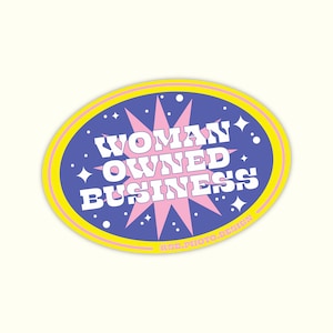 May include: A yellow and blue oval sticker with a pink starburst in the center. The text "WOMAN OWNED BUSINESS" is written in white letters on the sticker.