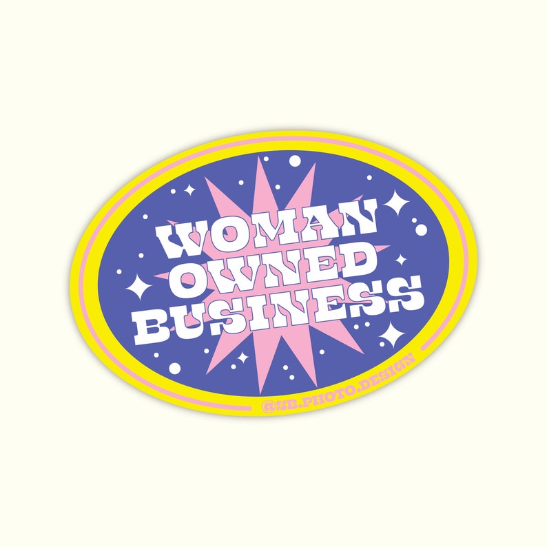 May include: A yellow and blue oval sticker with a pink starburst in the center. The text "WOMAN OWNED BUSINESS" is written in white letters on the sticker.