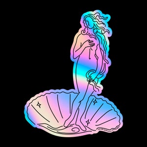 May include: A holographic sticker featuring a line drawing of the Birth of Venus, a famous Renaissance painting. The sticker is iridescent with a rainbow color scheme and features the text "@sb.photo.design".