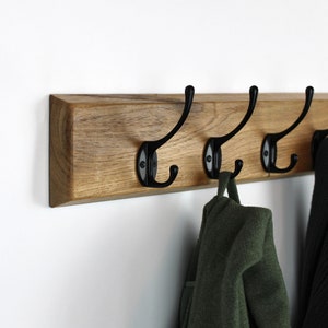 Wall coat rack with black gooseneck hooks