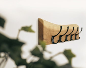 Coat rack with rustic forest edge and black gooseneck hooks