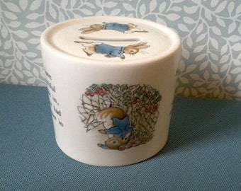 Wedgwood Peter Rabbit Money box-oval shape -pictures of Peter Rabbit -Made in England -7.5 cms tall