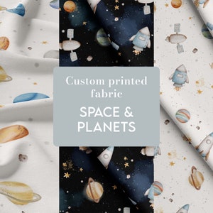 Op de afbeelding: Twee stofstalen met een ruimte- en planeten thema. Een staal is wit met gele, oranje en blauwe planeten, sterren en raketten. Het andere staal is zwart met hetzelfde ontwerp in wit, blauw en geel. De tekst "Op maat bedrukte stof" en "RUIMTE & PLANETEN" staat op een grijze rechthoek in het midden van de afbeelding.