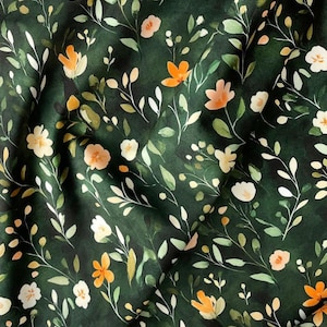 May include: A dark green fabric with a repeating pattern of small white, orange, and yellow flowers and leaves.