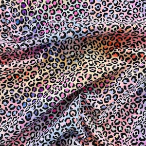 May include: A close-up of a fabric with a colorful leopard print. The pattern features black spots on a background of pink, purple, orange, and blue hues. The fabric is draped, showing the texture and flow of the material.
