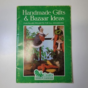 May include: A green book cover with the title "Handmade Gifts & Bazaar Ideas" and the text "FUN-FILLED PROJECTS FOR ALL OCCASIONS." The cover features illustrations of crafts, including a doll and vegetables. The logo "Crafts from Current" is at the bottom.