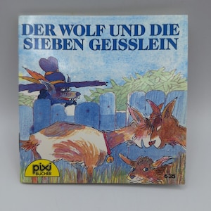 Puede incluir: Portada de libro infantil con el título "DER WOLF UND DIE SIEBEN GEISSLEIN" en azul. La ilustración representa un lobo con sombrero, cabras y una valla de madera. El libro tiene el logo "pixi BUCHER" y el número 635.