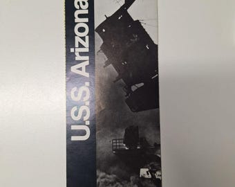 May include: A black and white photo of the USS Arizona, a battleship that was sunk during the attack on Pearl Harbor. The photo shows the ship partially submerged in the water, with smoke and debris in the air.