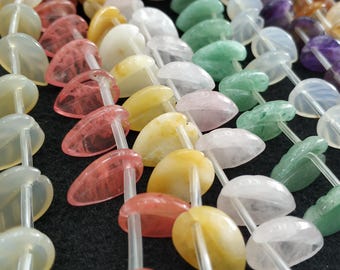 May include: A strand of heart-shaped gemstone beads in various colours, including pink, white, yellow, and green. The beads are strung on clear elastic cord.
