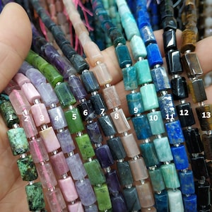May include: A close-up of 13 strands of gemstone beads, each strand featuring a different color and type of stone. The beads are rectangular and have a polished finish. The strands are numbered 1 through 13.