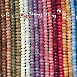 May include: A variety of 18 different colored gemstone beads, each strand numbered 59 to 83. The beads are round and have a faceted finish.