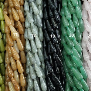 May include: Six strands of gemstone beads in various colours, including green, brown, grey, black, and pink. Each strand is labelled with a number from 16 to 21.