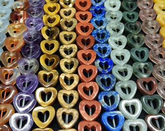 May include: A variety of heart-shaped gemstone beads with open centers. The beads are in shades of white, orange, purple, yellow, red, blue, and green.