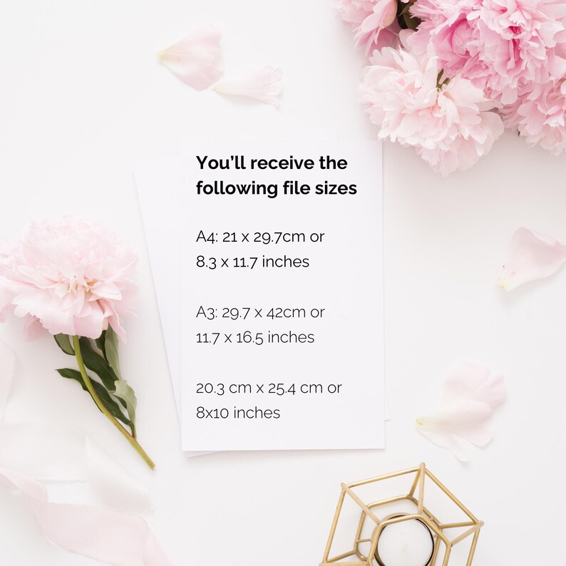 "Printable wall art size guide showing A4 (21 x 29.7 cm), A3 (29.7 x 42 cm), and 8x10 inches (20.3 x 25.4 cm) on a pink peony flatlay background. Includes both cm and inch measurements for digital download prints."